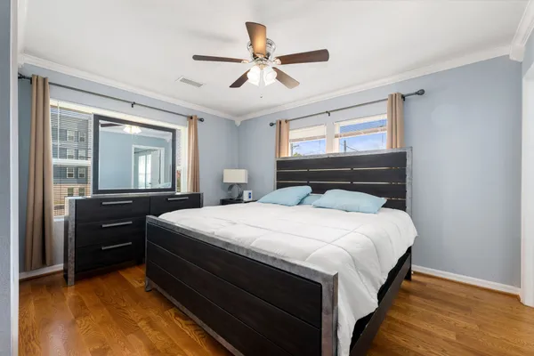 a large bed sitting in a bedroom and a chandelier