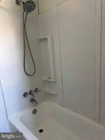a white toilet sitting next to a bath tub