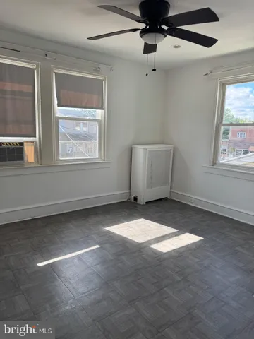 a view of a livingroom with a ceiling fan and entryway