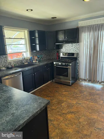 a kitchen with a granite countertop cabinets and refrigerator