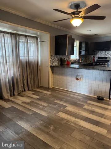 a view of a livingroom with a ceiling fan and window