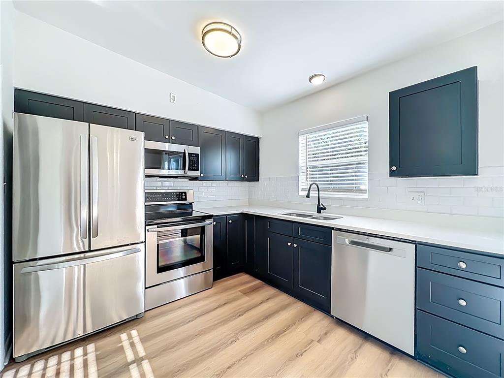 2001 Conway Gardens Road Orlando, FL 32812 - Photo 4 of 11 a kitchen with a refrigerator stove and sink