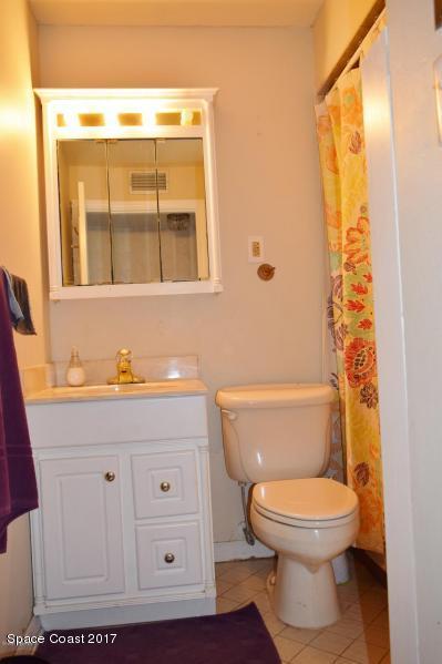 222 Brian Drive Indialantic, FL 32903 - Photo 11 of 14 a bathroom with a toilet a sink and a mirror