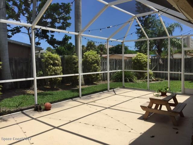 222 Brian Drive Indialantic, FL 32903 - Photo 14 of 14 a view of a backyard with table and chairs and potted plants