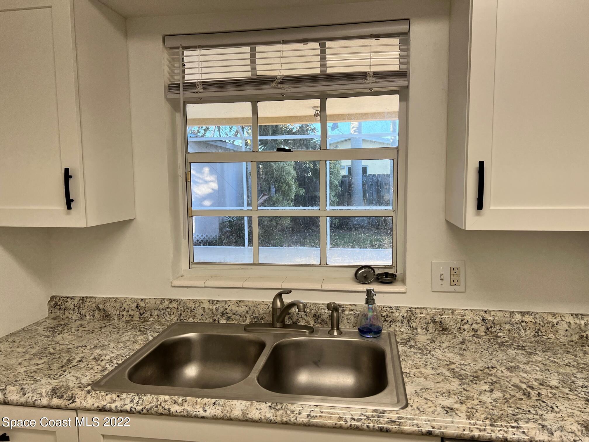 222 Brian Drive Indialantic, FL 32903 - Photo 8 of 14 a bathroom with a sink a vanity and mirror