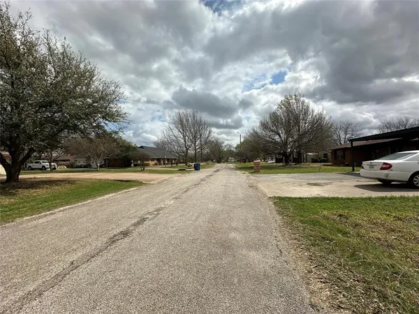 a view of road with cars parked