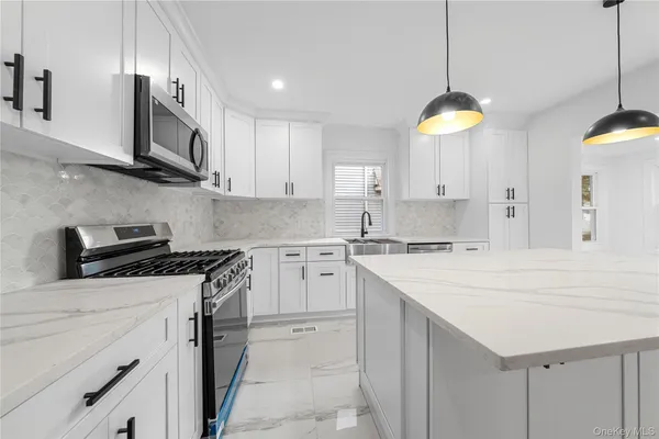 a kitchen with a sink a stove and cabinets