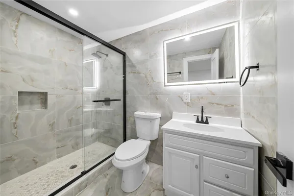 a bathroom with a sink a toilet and a mirror