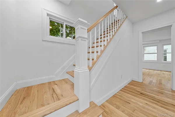 a view of entryway and hall with wooden floor