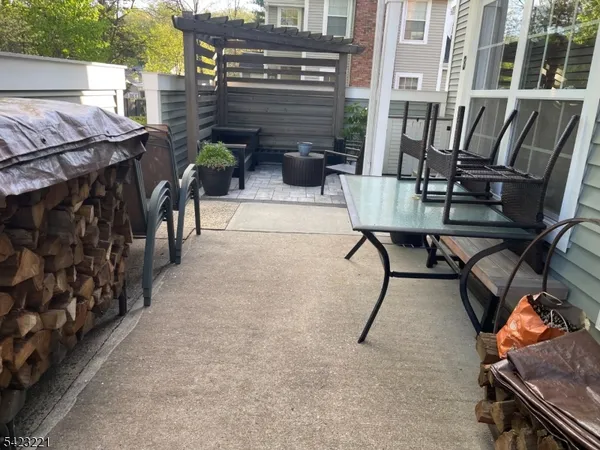 a view of a patio with couple of chairs and a potted plant