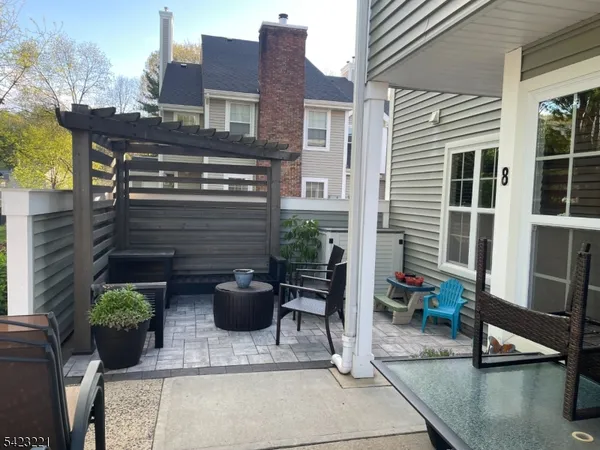 a view of a patio with table and chairs and potted plants