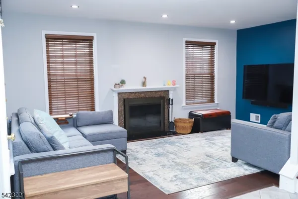 a living room with couches and a flat screen tv