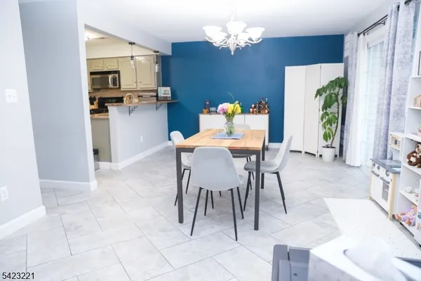a kitchen with a table chairs and refrigerator