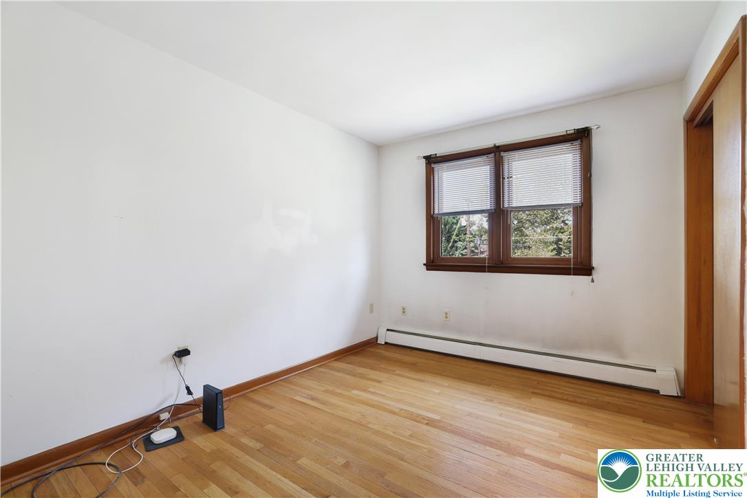 1539 Spring Garden Street Wilson, PA 18042 - Photo 19 of 34 Hardwood floors and natural wood trim frame a classic window in this versatile bedroom.