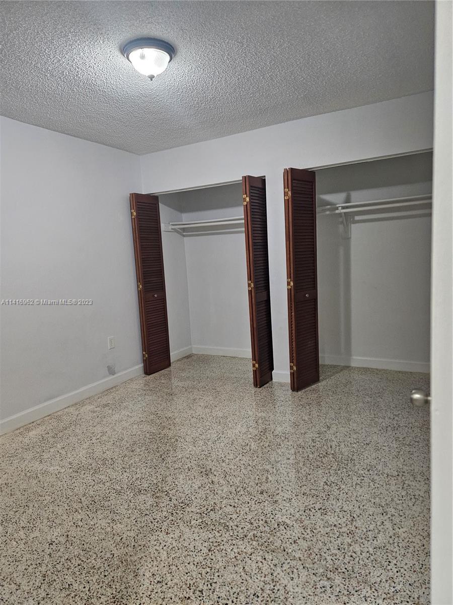 Allapattah Miami, FL 33125 - Photo 6 of 10 an empty room with closet and wooden floor