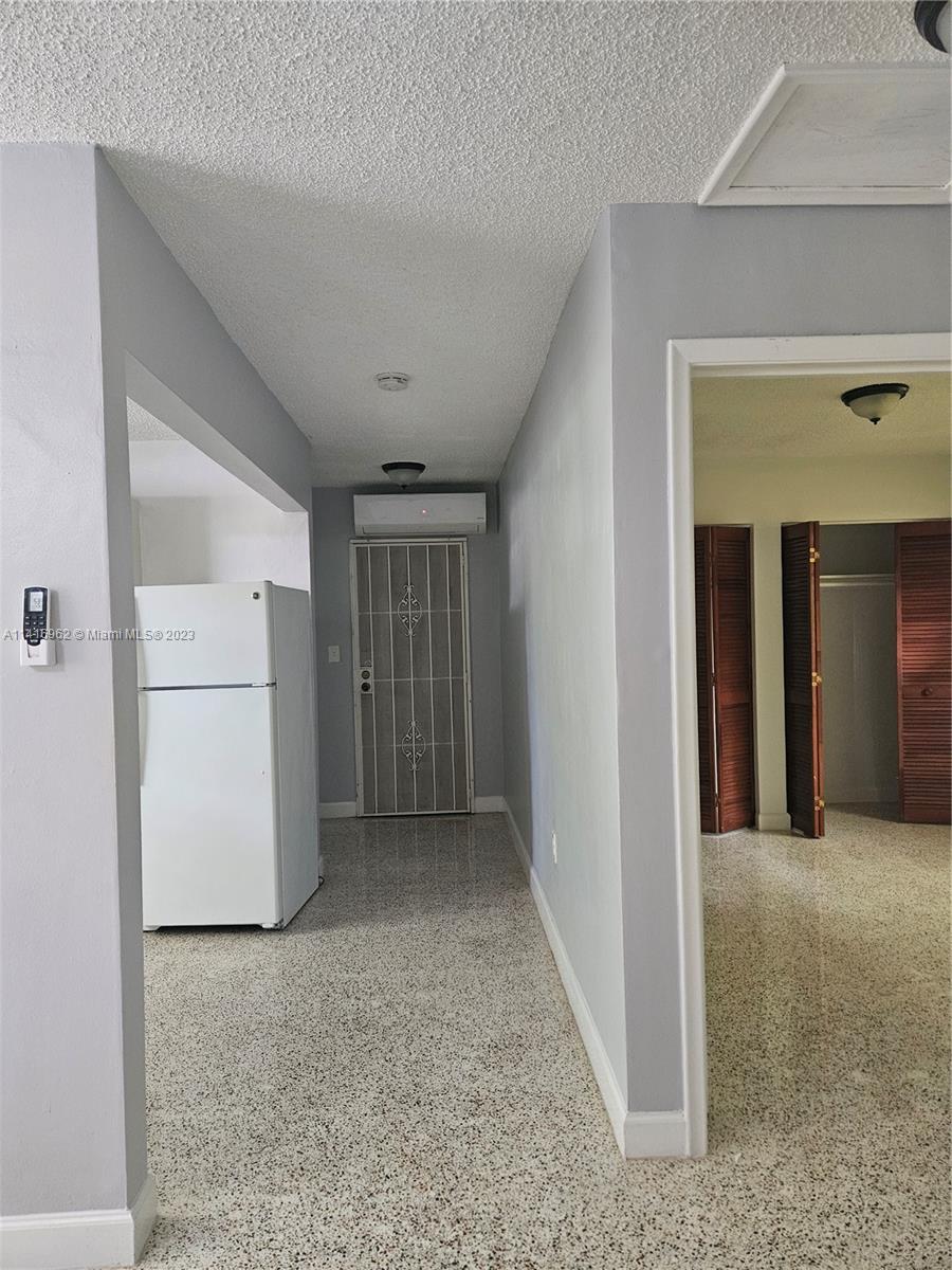 Allapattah Miami, FL 33125 - Photo 7 of 10 a view of a hallway with closet and cabinet