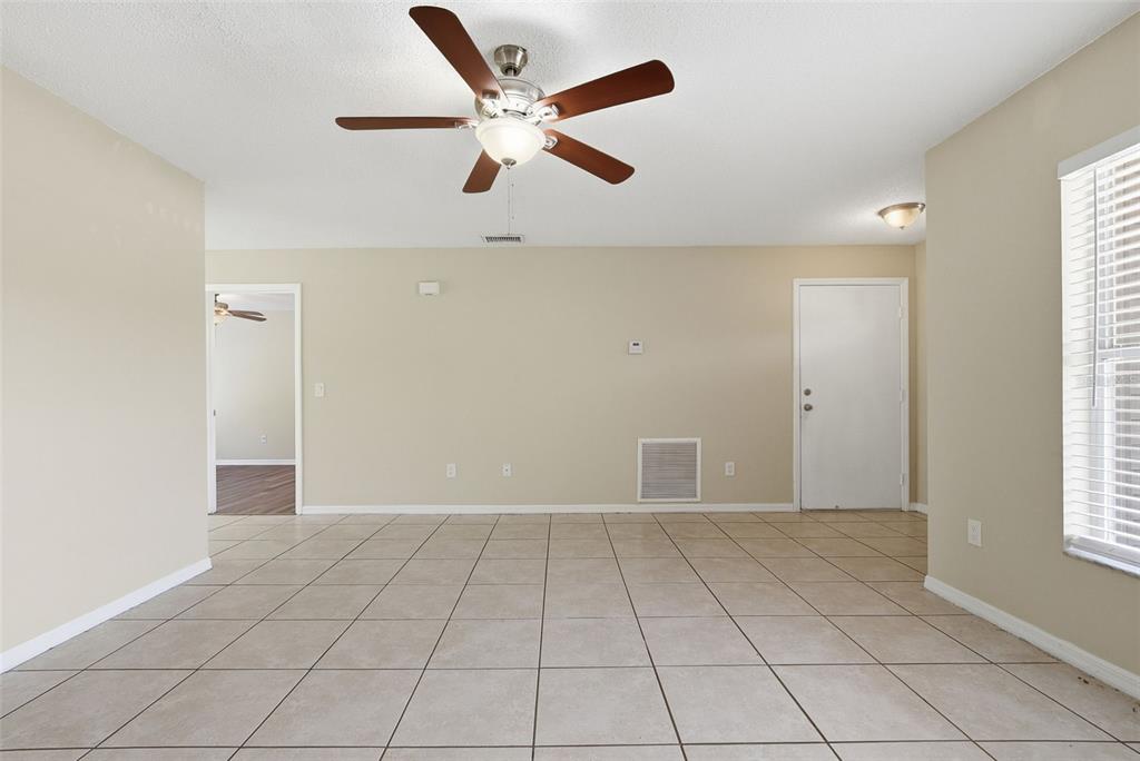 617 Greys Ferry Road Orlando, FL 32811 - Photo 9 of 35 an empty room with windows and fan