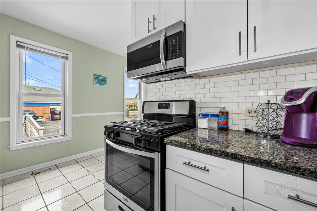320 Houston Street Batavia, IL 60510 - Photo 13 of 22 a kitchen with granite countertop a stove top oven microwave and cabinets