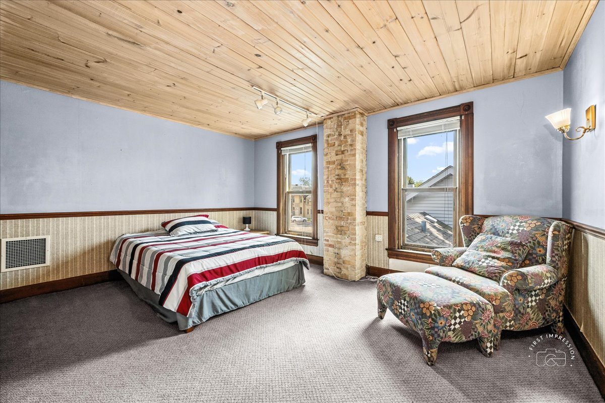 320 Houston Street Batavia, IL 60510 - Photo 16 of 22 a spacious bedroom with a bed and wooden floor