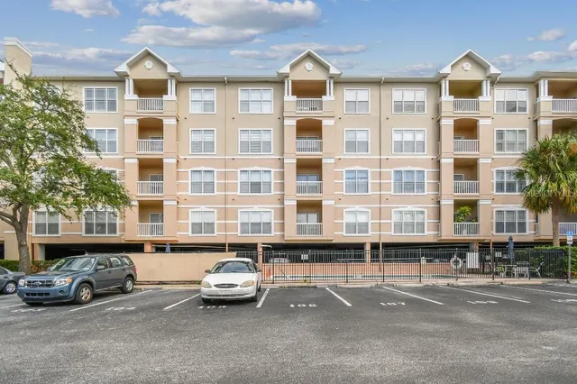 a front view of a residential apartment building with a yard