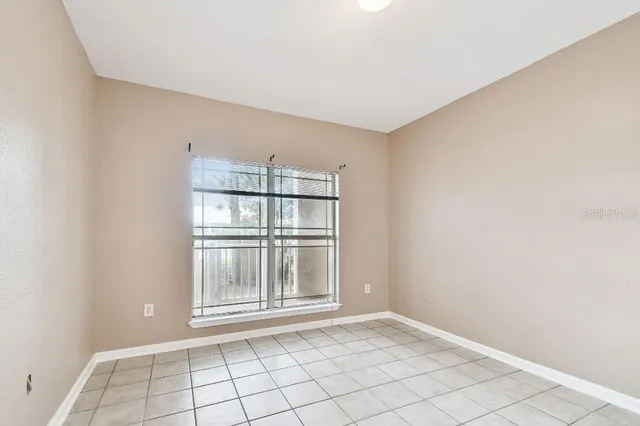 a room with gym equipment and windows