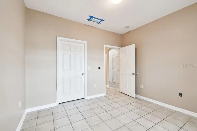 a room with gym equipment and view of living room