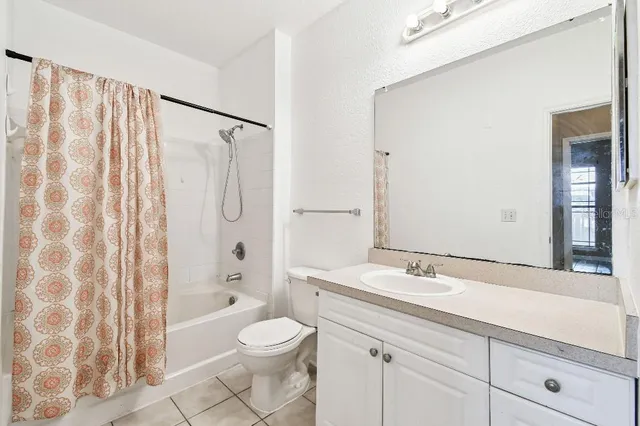 a living room with furniture and paintings on the wall