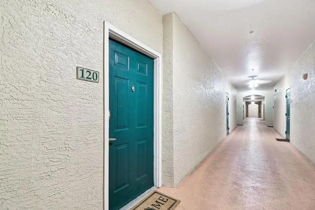 a view of a hallway with wooden floor and closet area
