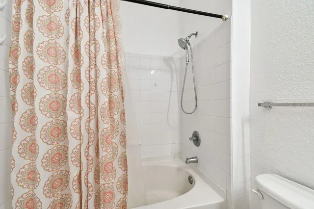 a kitchen with stainless steel appliances granite countertop a sink a stove white cabinets and a granite counter tops