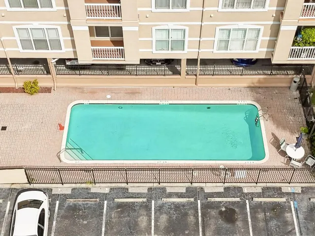 a view of a kitchen with cabinets and a refrigerator