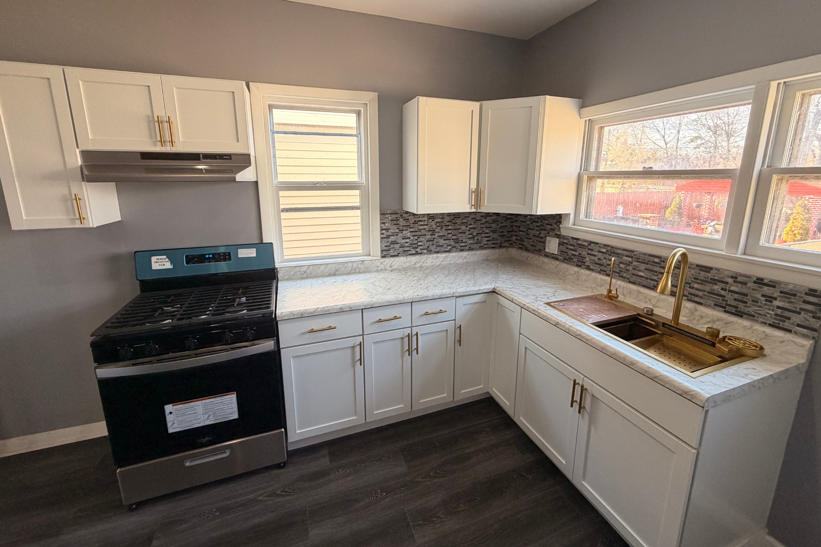 353 South 5th Avenue Kankakee, IL 60901 - Photo 5 of 12 a kitchen with a sink stove top oven and cabinets