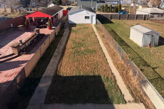 a view of a backyard with sitting area