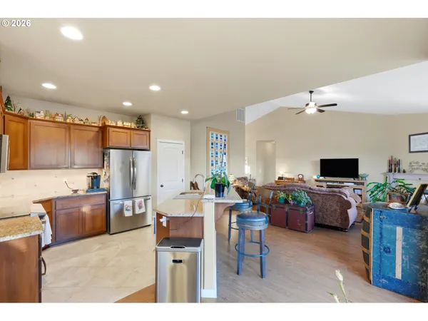 a living room with kitchen furniture and a flat screen tv