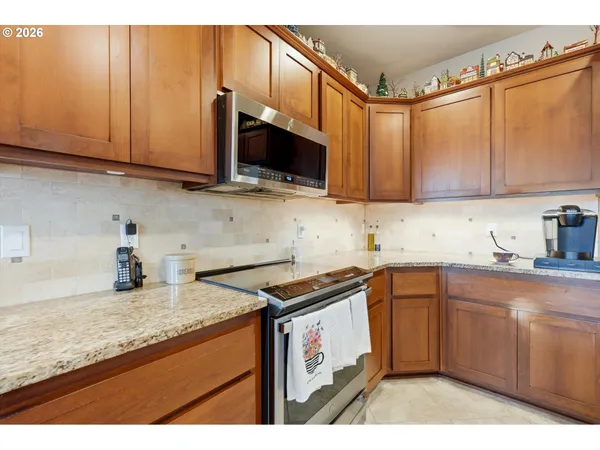 a kitchen with stainless steel appliances granite countertop a sink stove and microwave