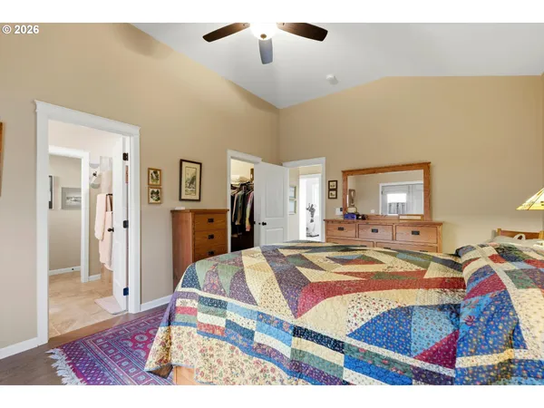 a bed room with a bed and a view of living room