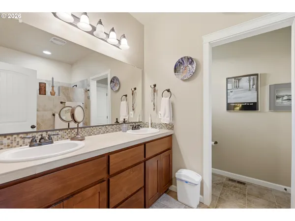 a bathroom with a granite countertop sink toilet and mirror