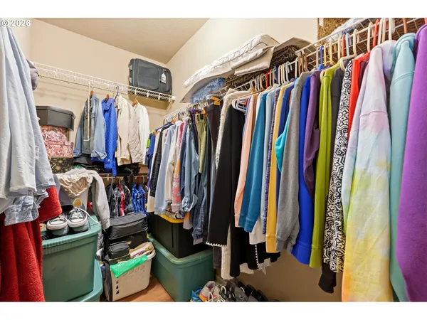 a view of walk in closet with clothes