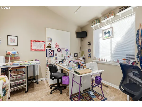 a view of a workspace with furniture and a window