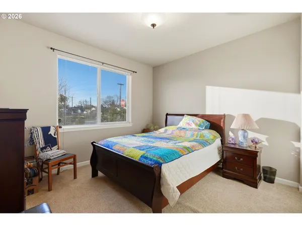 a bedroom with a bed and a table in it