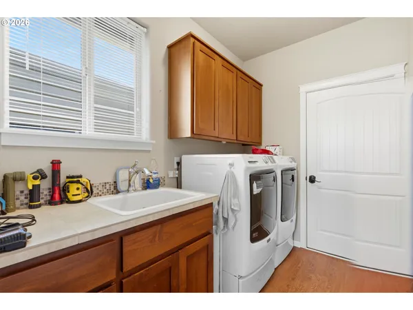 a utility room with sink dryer and washer