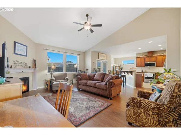 a living room with furniture kitchen view and a chandelier