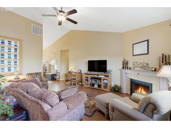 a living room with furniture a fireplace and a flat screen tv