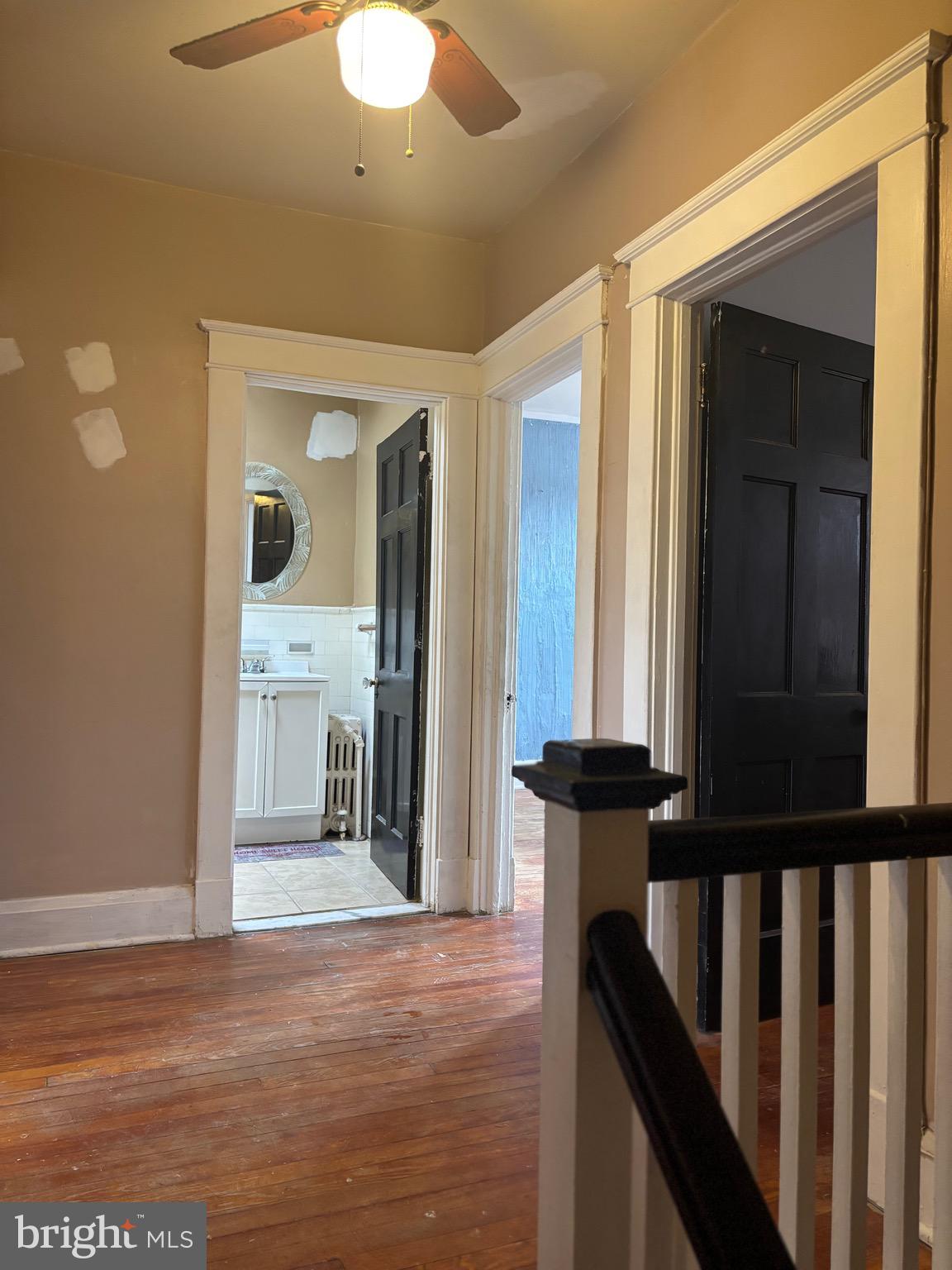 2417 North Pulaski Street Baltimore, MD 21217 - Photo 12 of 26 a view of a hallway with wooden floor and staircase