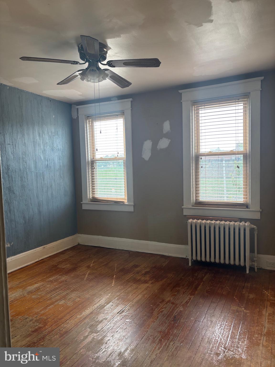 2417 North Pulaski Street Baltimore, MD 21217 - Photo 15 of 26 a view of an empty room with wooden floor and a window