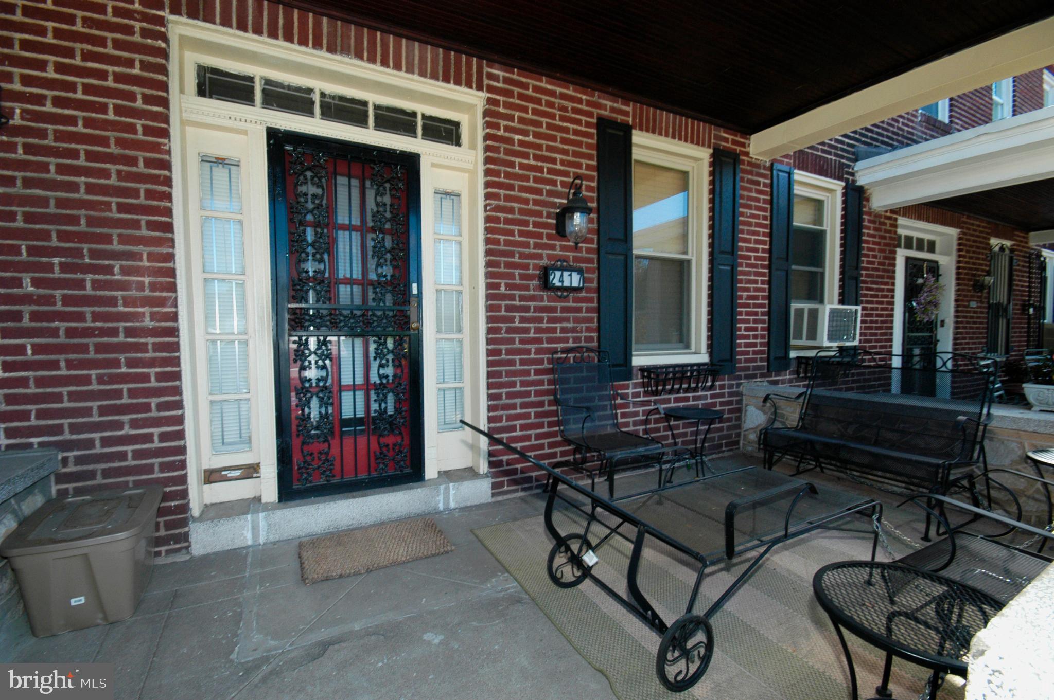 2417 North Pulaski Street Baltimore, MD 21217 - Photo 26 of 26 a bench is sitting in front of a brick building