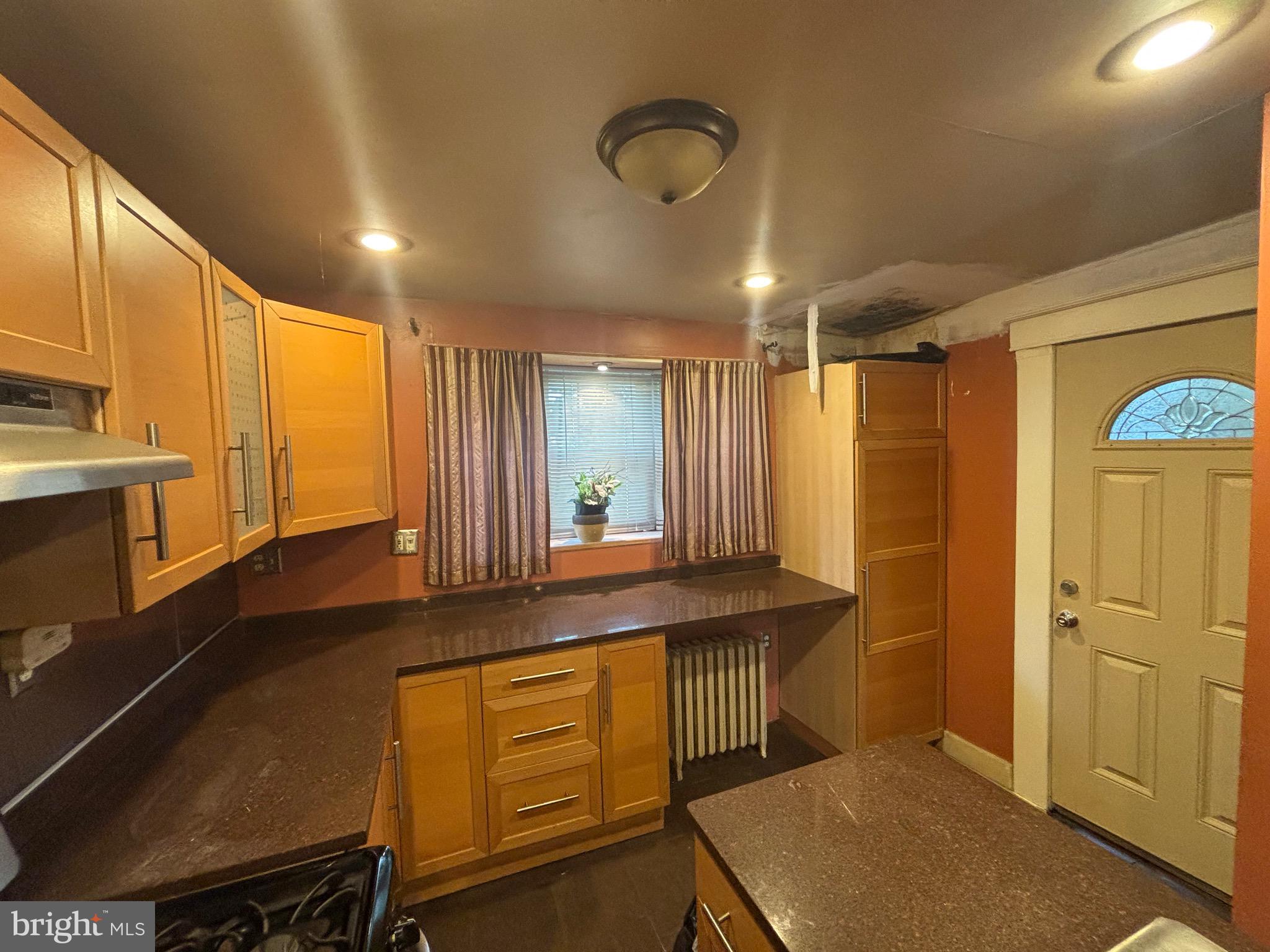 2417 North Pulaski Street Baltimore, MD 21217 - Photo 6 of 26 a kitchen with stainless steel appliances granite countertop a sink a stove and a refrigerator