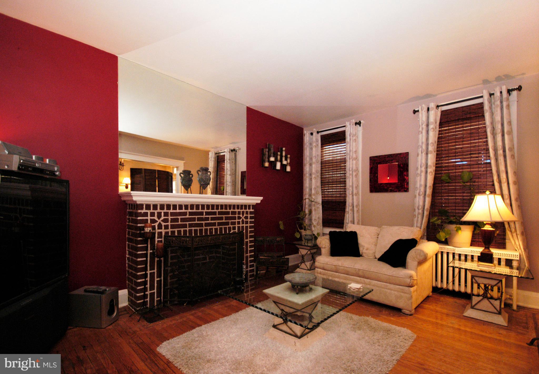 2417 North Pulaski Street Baltimore, MD 21217 - Photo 10 of 26 a living room with furniture a rug and a fireplace