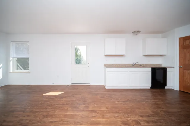 a view of kitchen with wooden cabinet