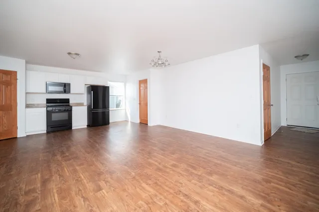 a view of a kitchen with a stove cabinets and wooden floor