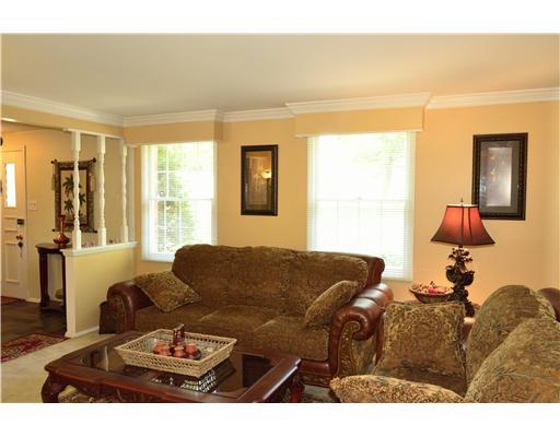 Living Room. Crown molding and plush carpeting accent the living room.